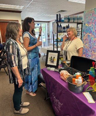 Wellness vendor and customers talking at Reenew festival